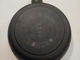 a black frying pan on a white table