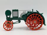 a green and red model of a tractor on a white surface