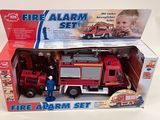 a toy fire truck and a fireman set in the box