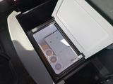 a small refrigerator in the back of a car with its door open
