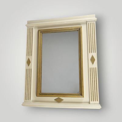 a mirror on the wall above a shelf with a mirror