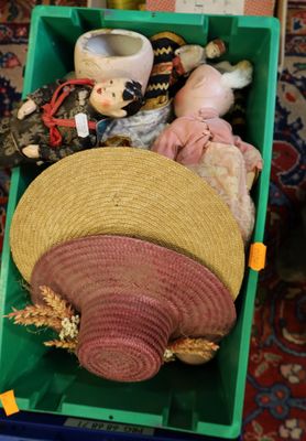 a green box filled with assorted items on the floor