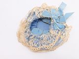 a small blue hat with a bow on top of it