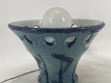 a blue bowl with a white egg inside of it