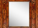 an image of a wooden mirror with carvings on it