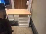 a desk with a chair and a computer on it