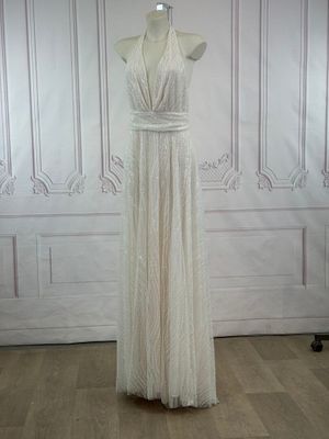 a white dress on a mannequin stand in a room