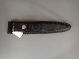 a knife that has a piece of paper on it