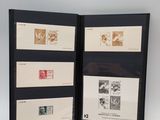 two black picture frames with stamps on them on a white surface