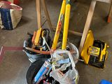 a pile of tools sitting on the floor in a garage