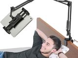 an image of a man laying on a bed with a laptop on his lap