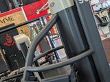 a gym room with a row of machines and other equipment