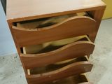 a wooden dresser with four drawers in it