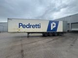 the trailer is parked in front of a building with a sign on it