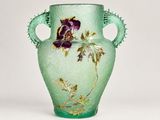 a green vase with a purple flower on it