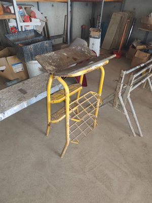 une chaise jaune dans une pièce où il y a beaucoup de cartons