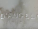 a close up of a white vase with a name on it