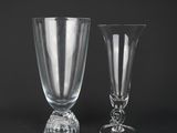 pair of clear glass goblets sitting on a black surface