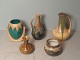 five different types of vases sitting on a table