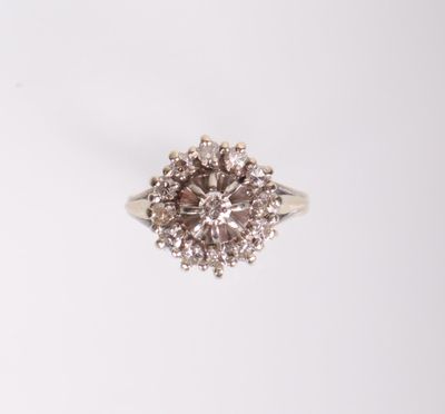a white gold ring with a brown and white diamond center