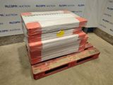 une pile de cartons posée sur une palette devant un mur