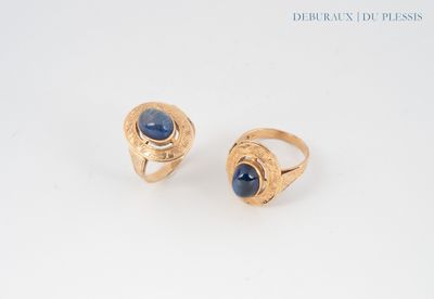 two gold rings with a blue stone in the middle