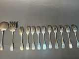 a lot of forks and spoons sitting on a table