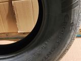 a close up of a tire on a cardboard box with a cardboard box in the background