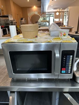 a microwave sitting on top of a table in a kitchen