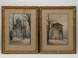 two framed paintings of a building and trees in a room