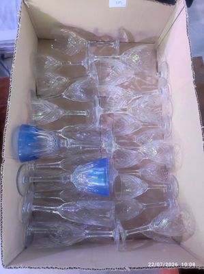 a box full of empty wine glasses sitting on a table
