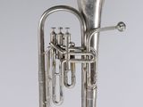 an antique silver plated musical instrument on a white background