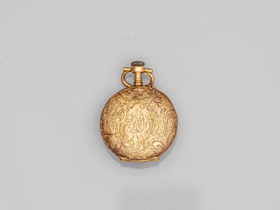an antique gold flaskt with a handle on a white surface