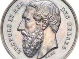 an old coin with a man ' s face and a beard on it