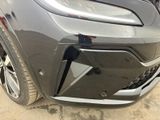 the front bumper of a gray car with a broken bumper