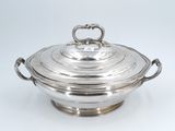 an antique silver plate covered casserole with handles and handles