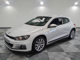 the white volkswagen golf is parked on a checkered tile floor