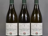 three bottles of wine are lined up on a table
