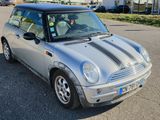 a small silver car that is parked in a parking lot
