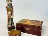 wooden figurine of a man and a box on a white surface
