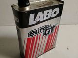a can of soda sitting on a table next to a white wall