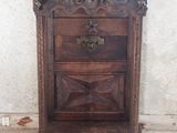 a wooden cabinet with a metal bowl on top of it