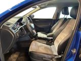 the interior of a blue car with two seats and a steering wheel
