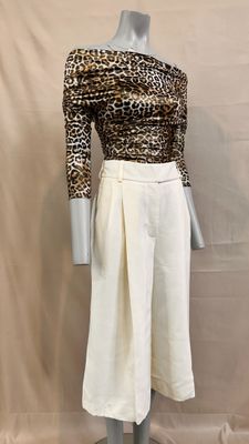 the mannequin is wearing a leopard print top and white skirt