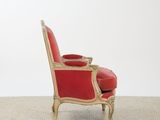 an image of a red and gold chair with a red cushion
