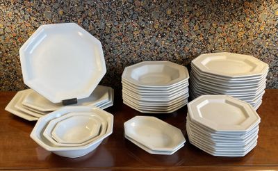 a lot of plates and bowls on the table