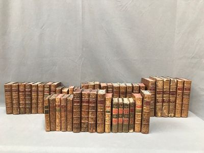 a bunch of old books sitting on top of a white table