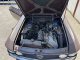 an old car with its hood open and the engine in the trunk
