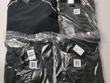 two pairs of men ' s shirts wrapped in plastic on a table