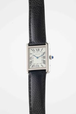 a close up of a wrist watch with roman numerals on it